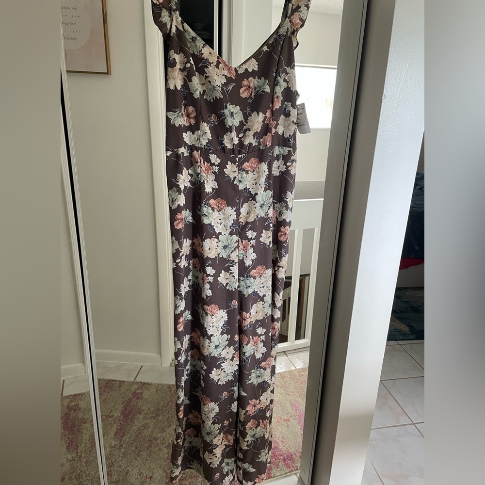Floral jumper with a little peekaboo in the back. Brand new with tags still on.
